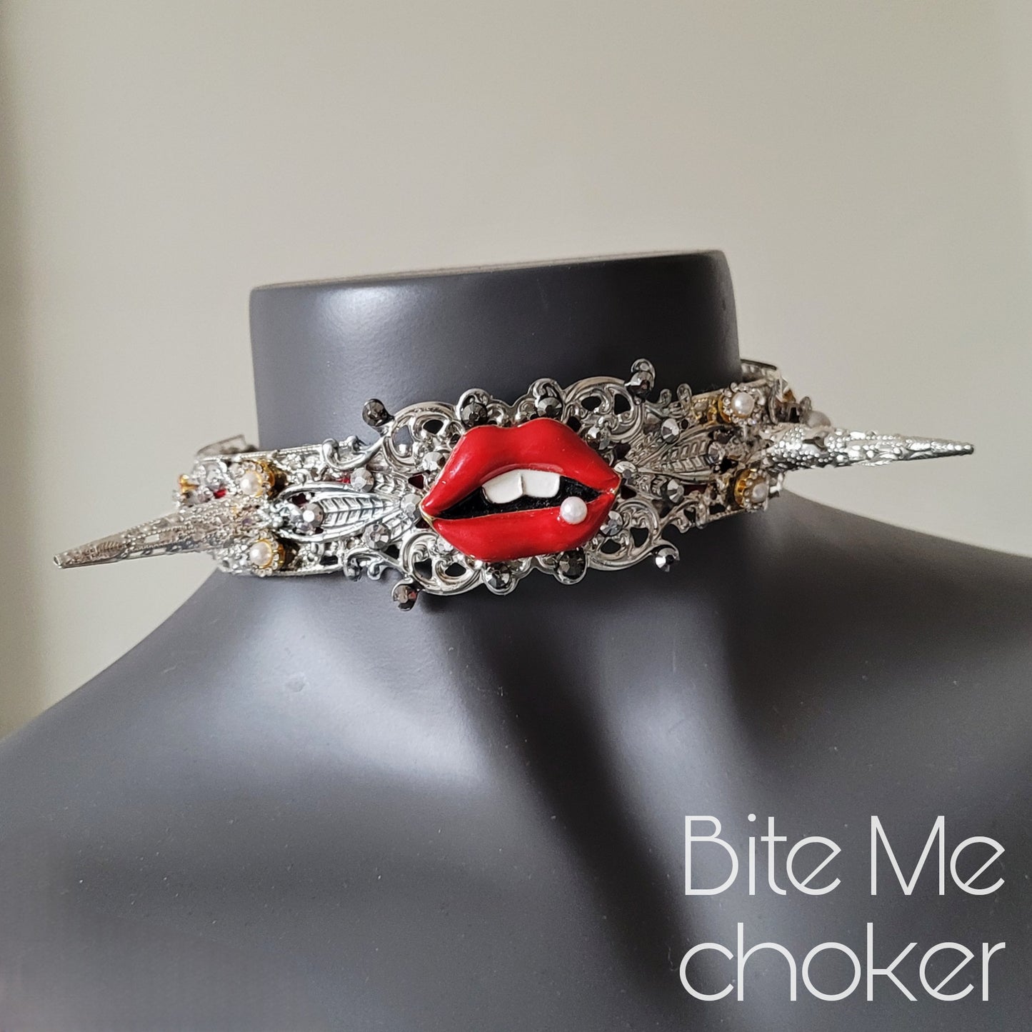 WhatEver collection: The Bite Me metal choker with red enamel lips adorned with a single pearl, two filigree spikes, faux pearls, rhinestones and high quality glass crystals