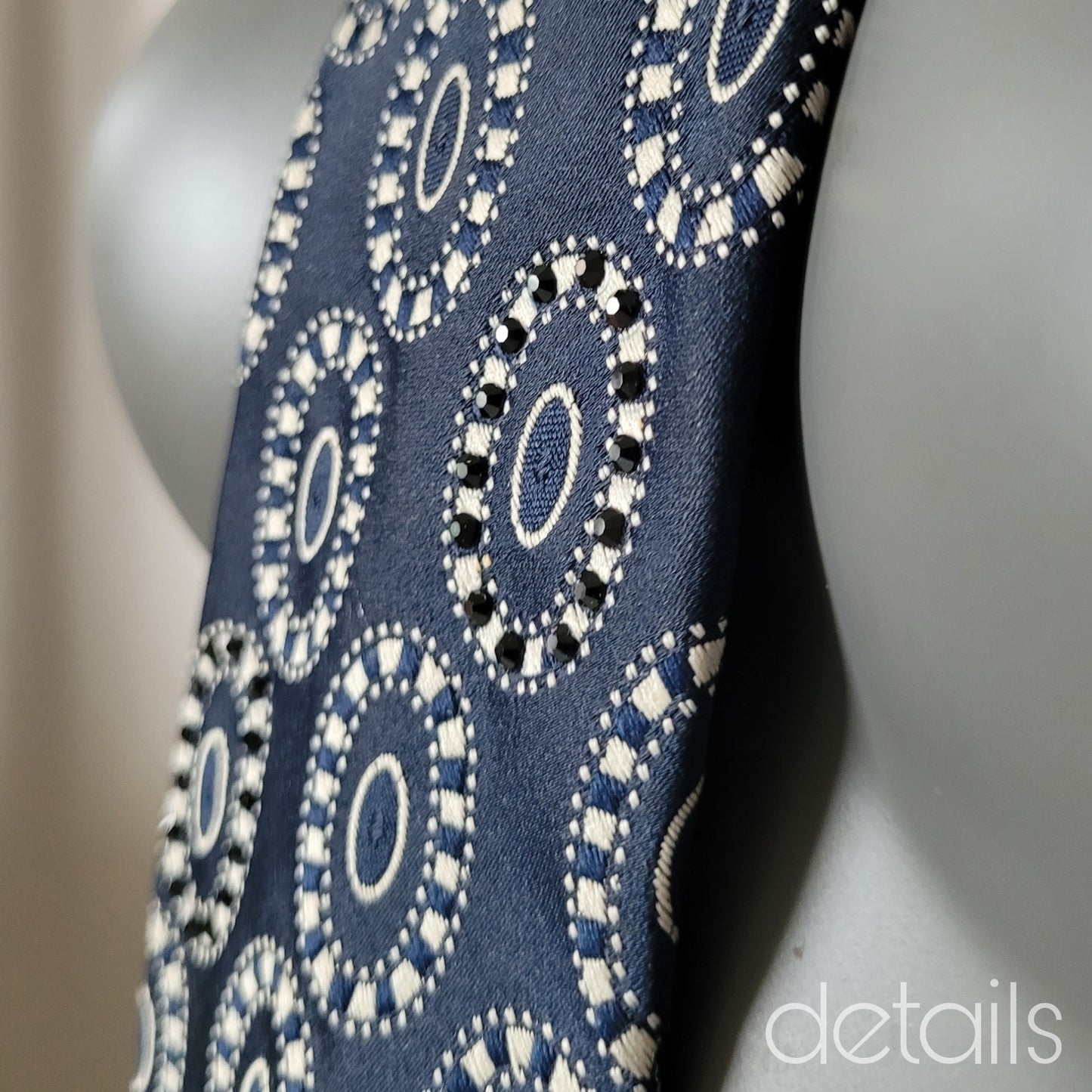 Another Dance collection: Gossip tie, dark navy necktie with white medallion pattern adorned with crystal clear and jet black glass crystals