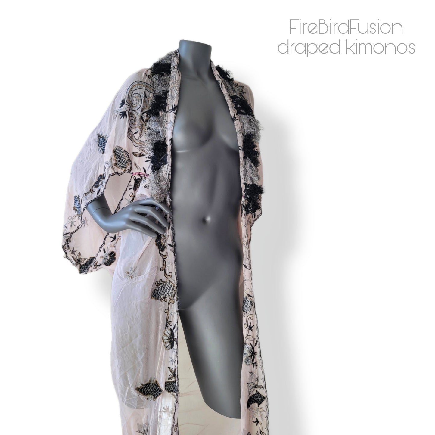 Draped kimono in super pale pink with black & gray embroidery, golden and amber highlights, and striped fringe (M)