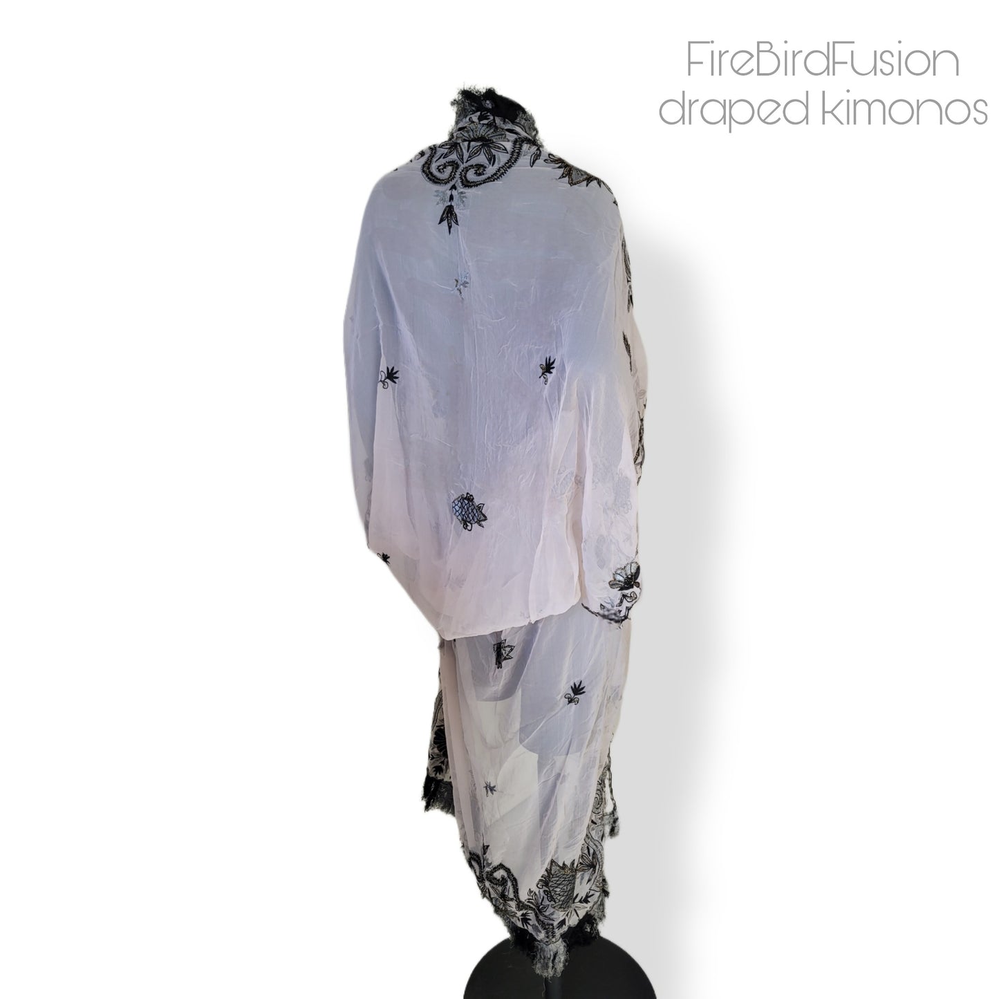 Draped kimono in super pale pink with black & gray embroidery, golden and amber highlights, and striped fringe (M)