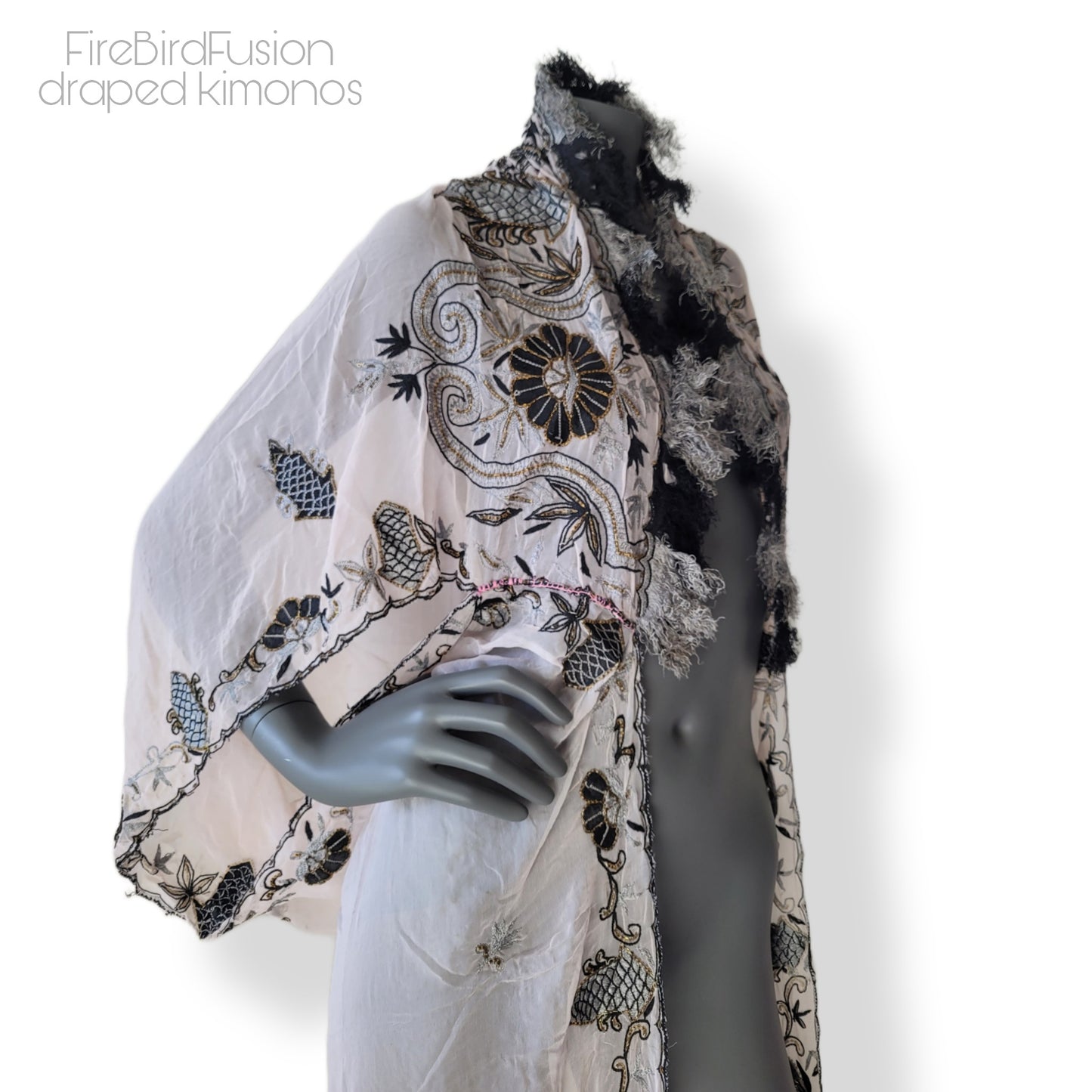 Draped kimono in super pale pink with black & gray embroidery, golden and amber highlights, and striped fringe (M)