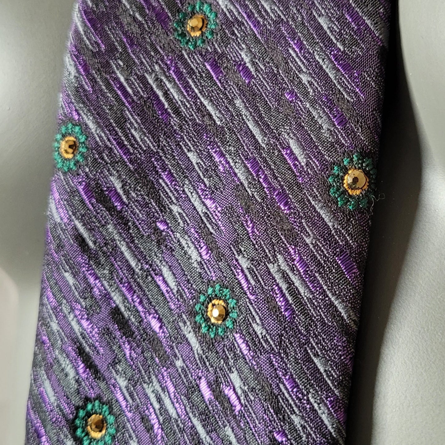 Another Dance collection: Riders on the Storm tie, vintage polyester necktie diagonally striped in purple and black with small green flowers adorned with shimmering mine gold glass crystals