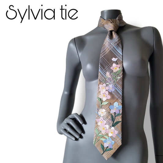 Suffragettes collection: Sylvia tie, vintage silk necktie in soft brown with diagonally checked stripes in blue and bronze, adorned with embroidered flower appliques in shades of pink and blue, and a multitude of shimmering glass crystals