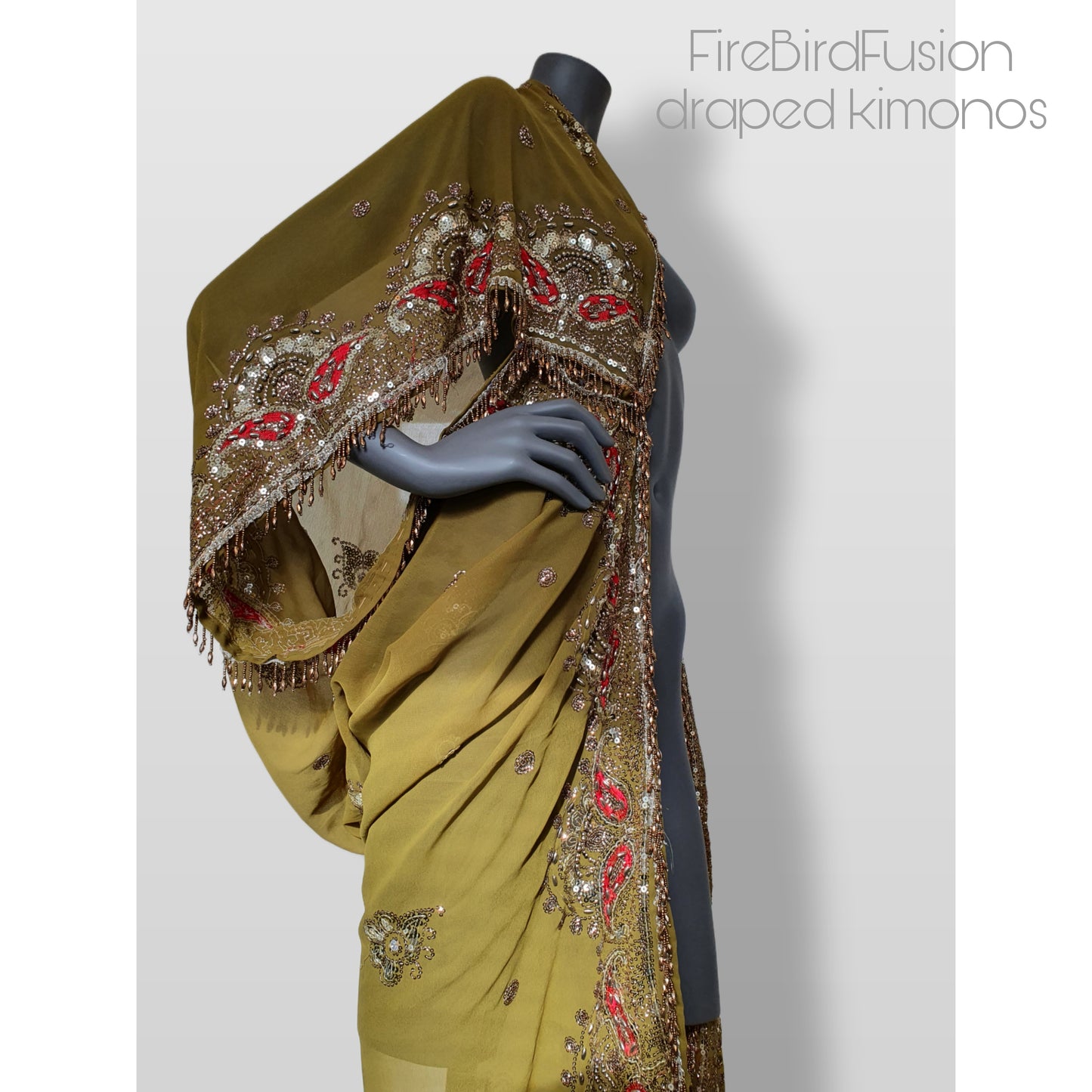 Draped kimono in light olive green with broad embroidered trim in gold, silver and red and beaded fringe (M)