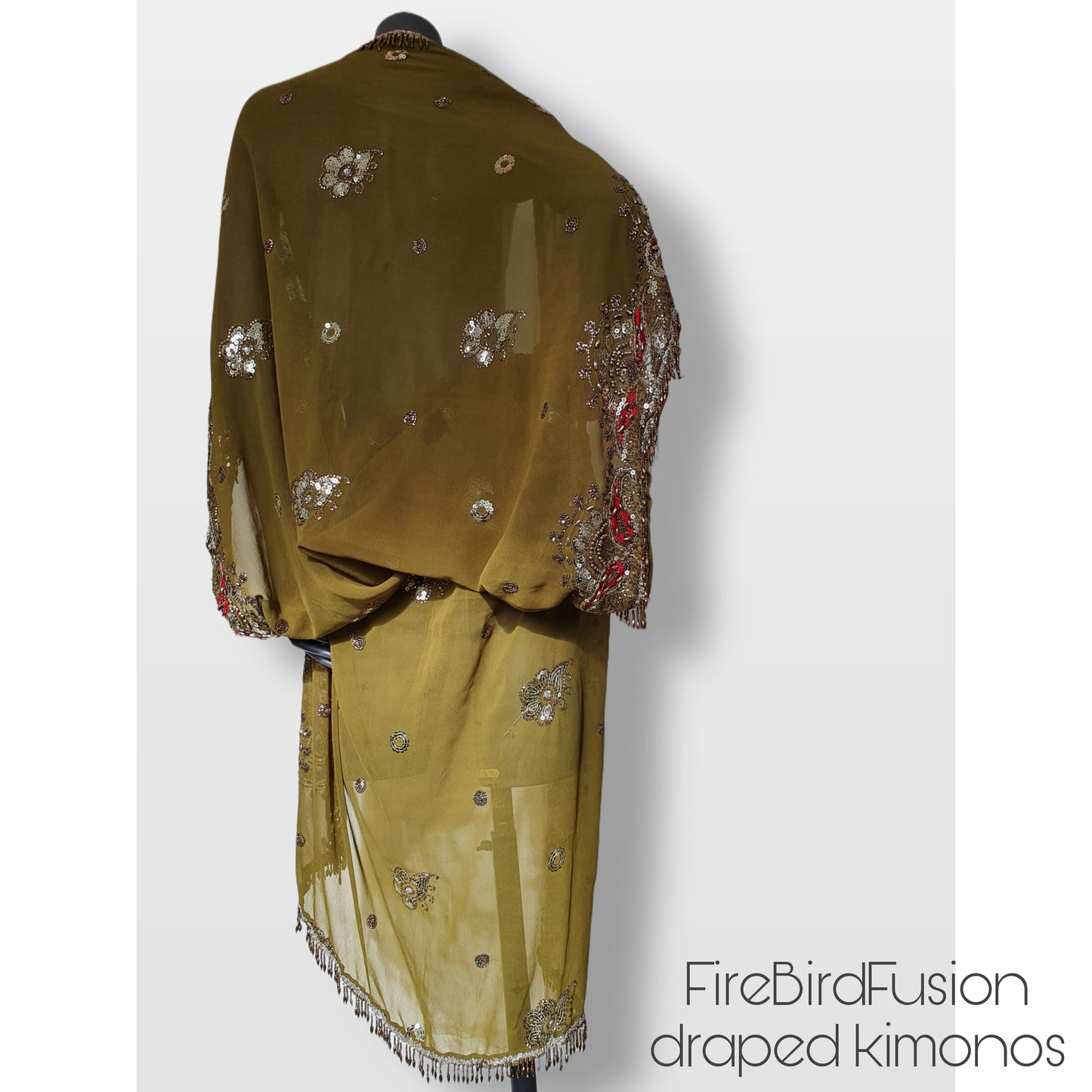 Draped kimono in light olive green with broad embroidered trim in gold, silver and red and beaded fringe (M)