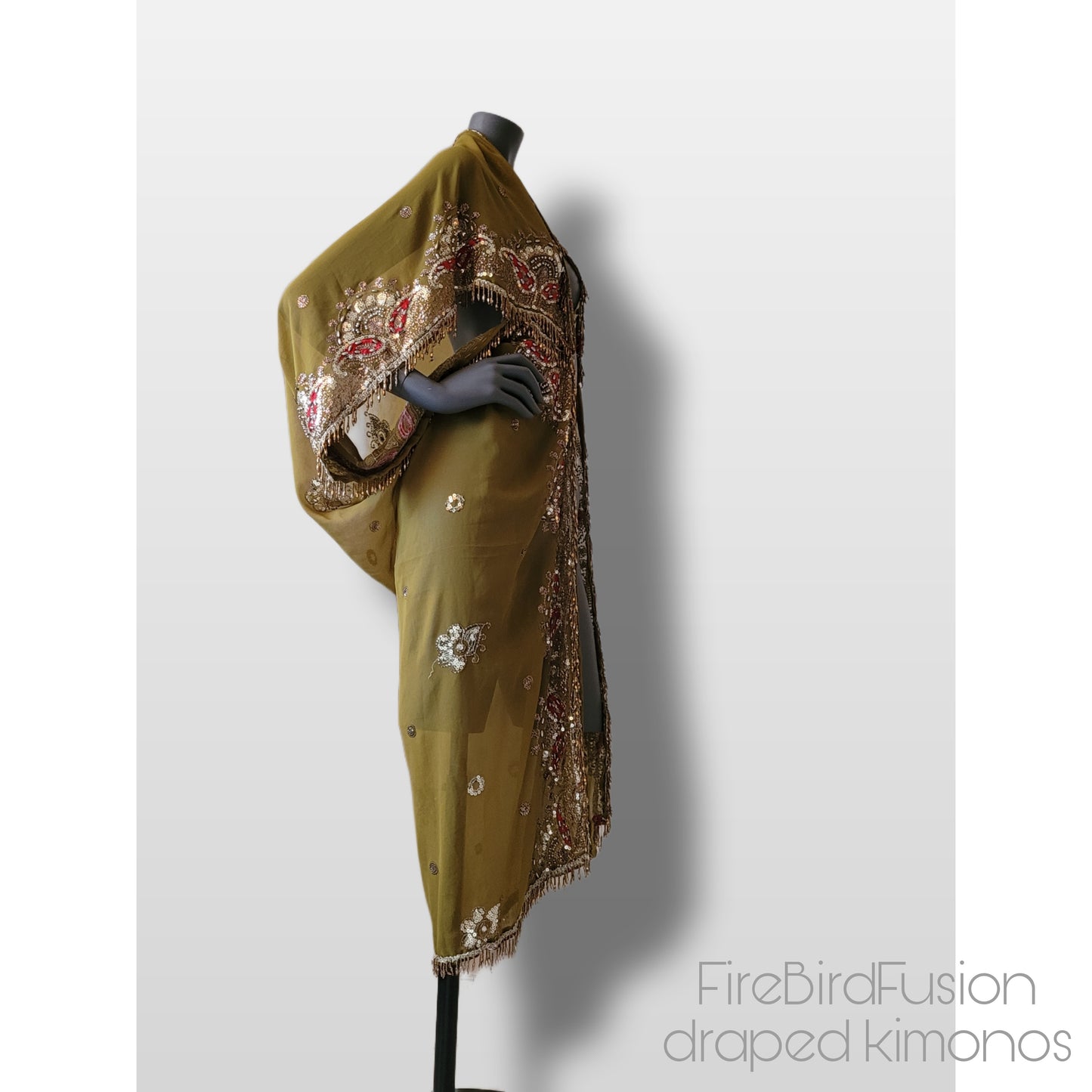 Draped kimono in light olive green with broad embroidered trim in gold, silver and red and beaded fringe (M)