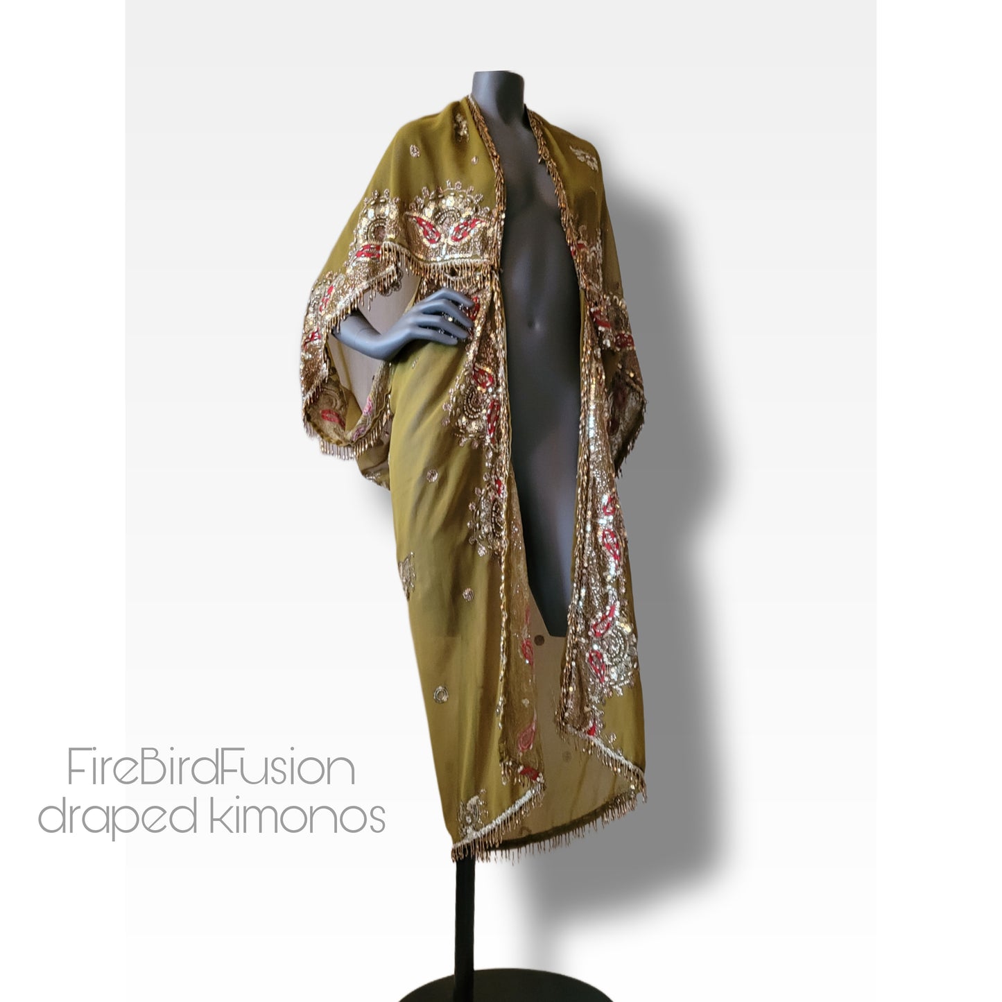 Draped kimono in light olive green with broad embroidered trim in gold, silver and red and beaded fringe (M)
