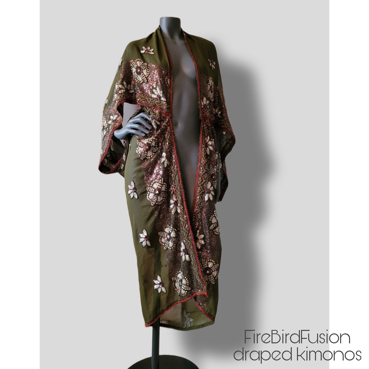 Draped kimono in light olive green with golden shine and broad embroidered trim in wine red, silver and bronze (M-L)