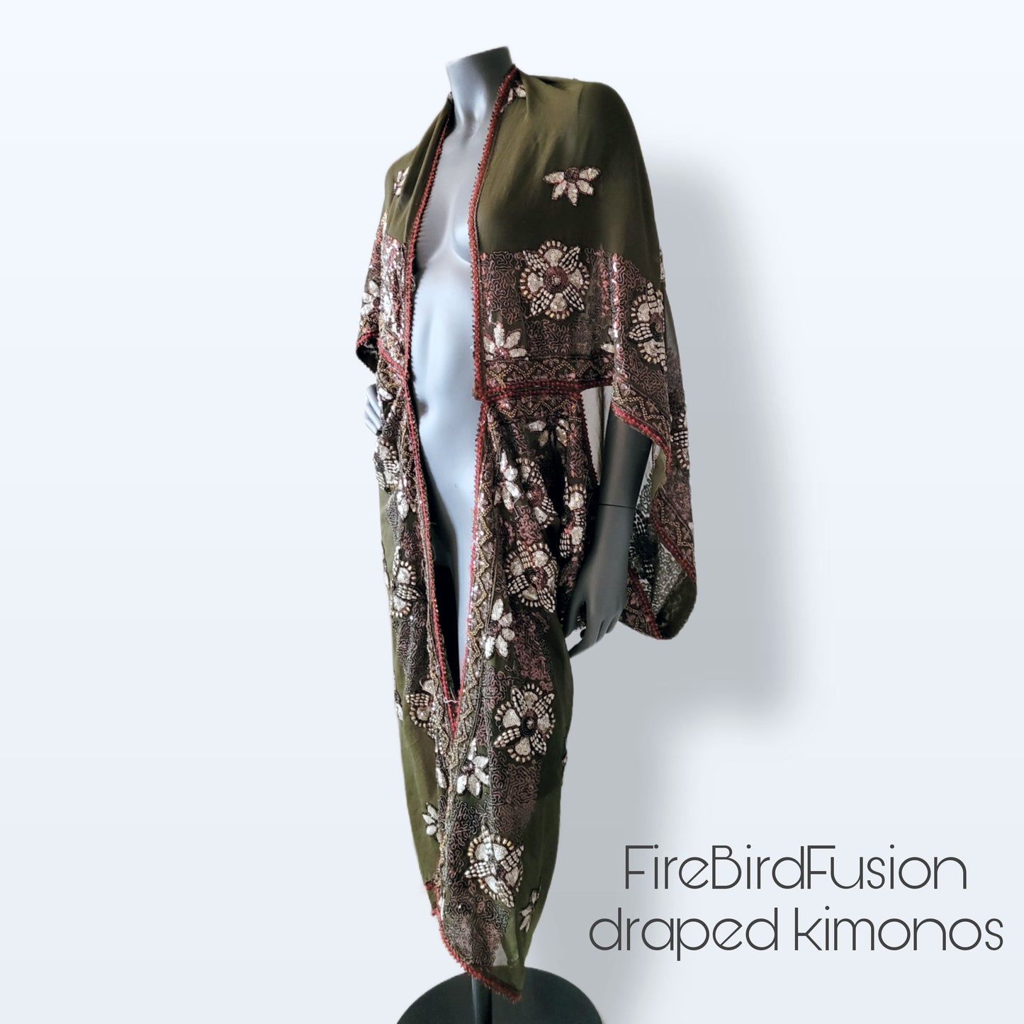 Draped kimono in light olive green with golden shine and broad embroidered trim in wine red, silver and bronze (M-L)