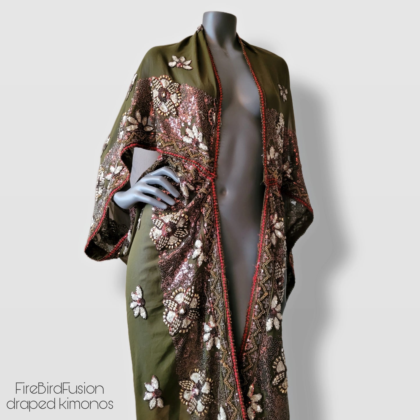 Draped kimono in light olive green with golden shine and broad embroidered trim in wine red, silver and bronze (M-L)