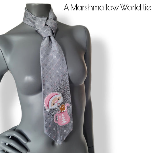 Another Dance collection, Christmas 2025 edition: A Marshmallow World tie, vintage silk necktie with small square pattern in gray, pink, and white with Santa enjoying a cup of hot chocolate surrounded by shimmering black diamond glass crystals