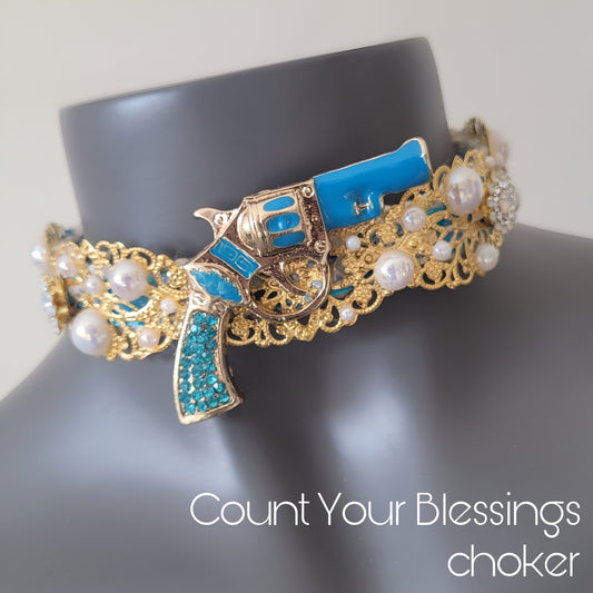 WhatEver collection: The Count Your Blessings metal choker with a turquoise blue revolver and faux irredecent pearls