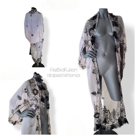Draped kimono in super pale pink with black & gray embroidery, golden and amber highlights, and striped fringe (M)