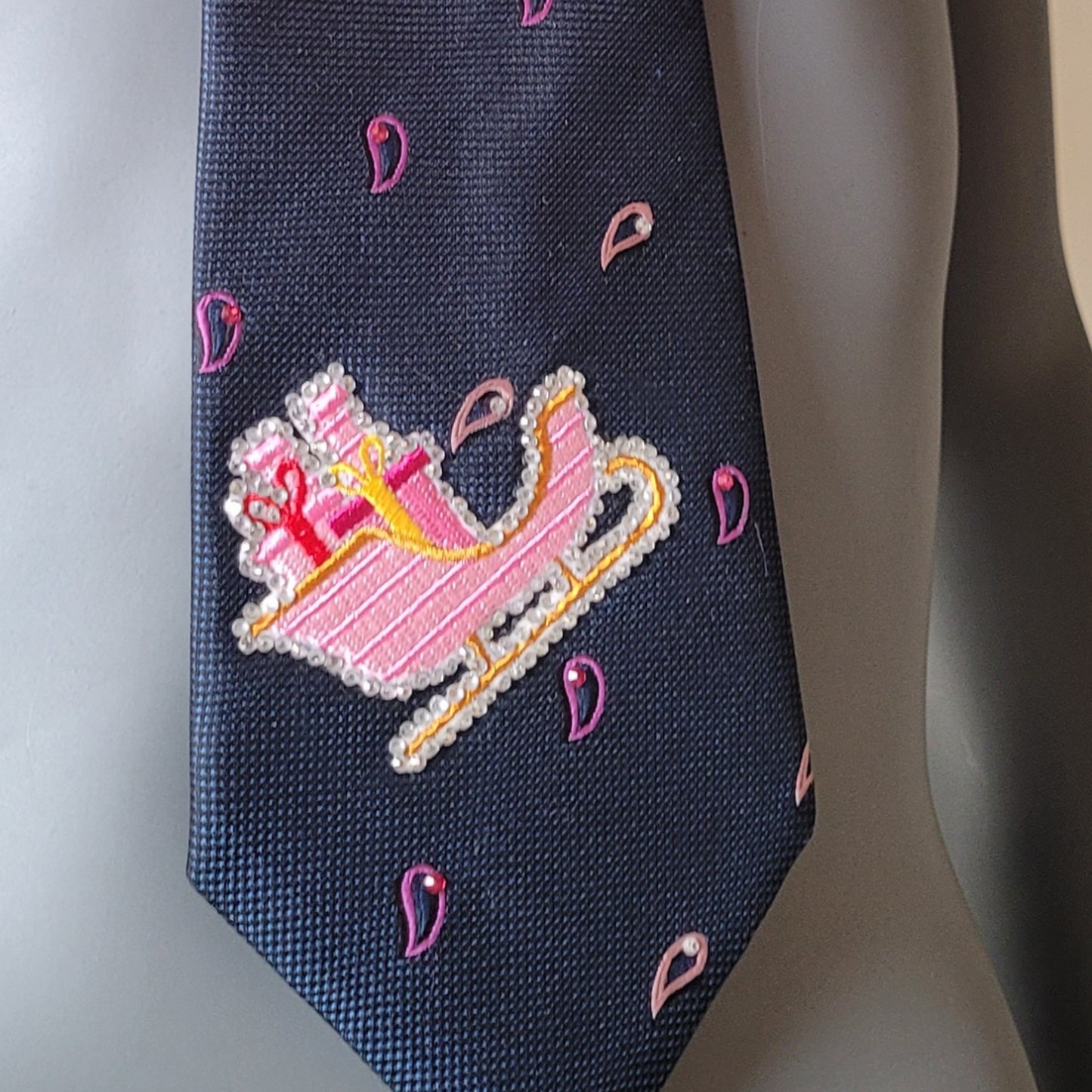 Another Dance collection, Christmas 2025 edition: Sleigh Ride tie, vintage navy polyester necktie with drop pattern in pink shades turned into Christmas spirit with Santa's pink sleigh and shimmering glass crystals