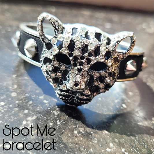WhatEver collection: The Spot Me bracelet, adorned with a sparkling leopard head, black faux leather, and silver studs